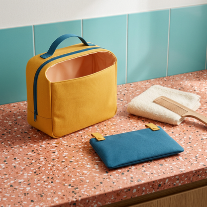 AI concept bathroom-counter scene with yellow main bag and blue flat pouch.