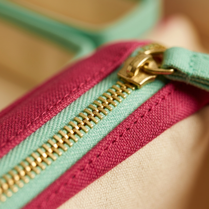 AI concept macro detail of zipper teeth, mint zipper tape and raspberry fabric stitching.