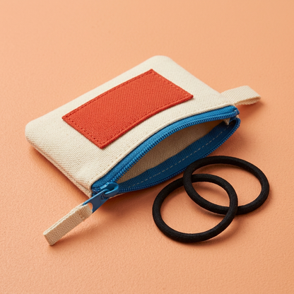 AI concept cream pouch with illustrative hair ties, not included.